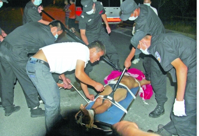 眾人合力將狂犬病發(fā)作的江某控制住。 孫東城 攝