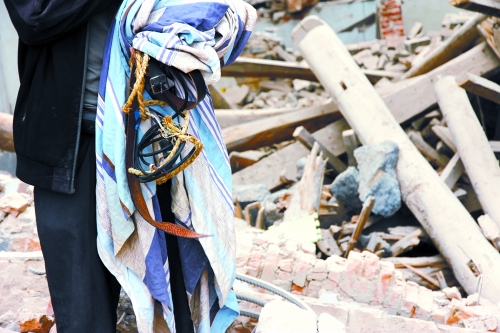 老人手中拿著曾控制住他的電線、床單