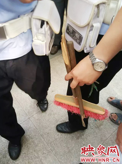 老太從環(huán)衛(wèi)工手中奪過掃帚，用腳踩斷，用力向環(huán)衛(wèi)工人的手上和腿上敲去。