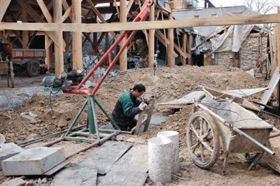 東城區(qū)北鑼鼓巷與小經(jīng)廠胡同之間一處四合院內(nèi)，工人進(jìn)入已經(jīng)挖好的地下室內(nèi)施工。